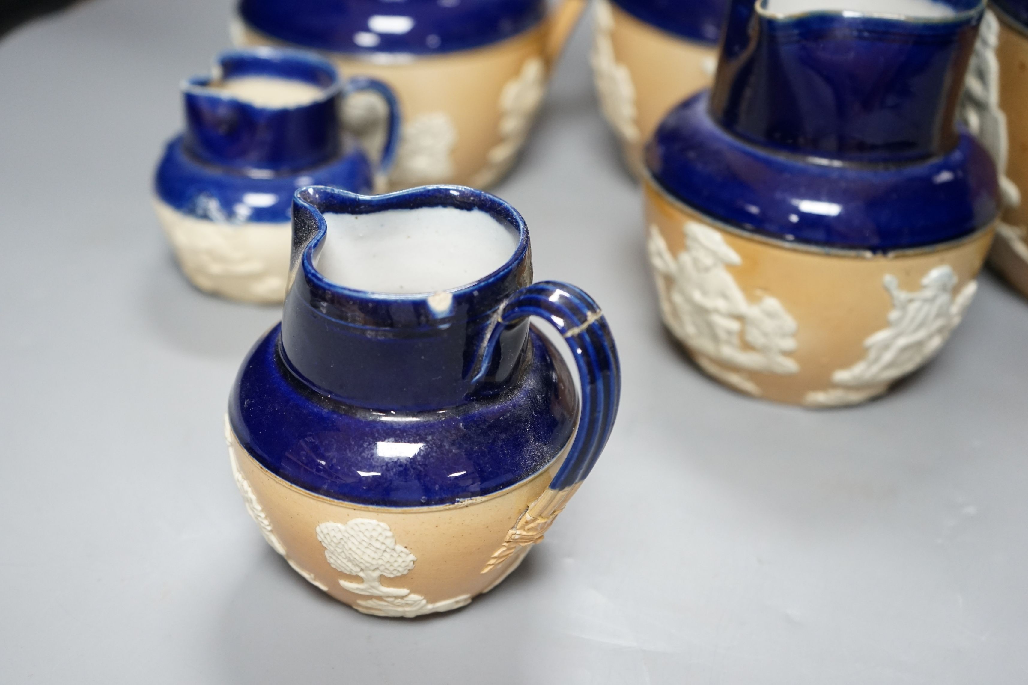A set of six graduated set of Royal Doulton harvest jugs